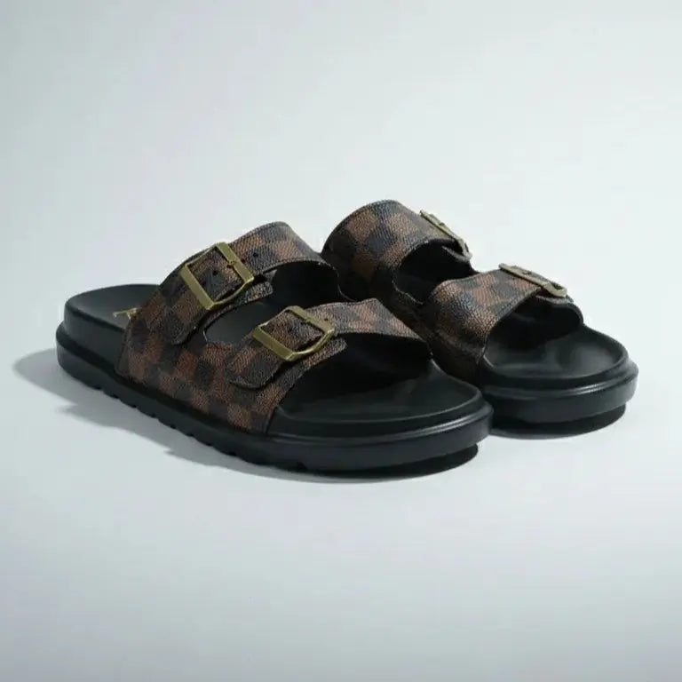 Pair of brown sandals with black soles on a light gray background