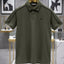 Green polo shirt on a hanger with a blurred store interior background
