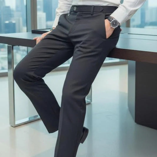 Person wearing a white shirt and dark pants in an office setting with a cityscape view.