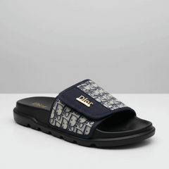 Navy slide sandal with patterned strap on a white background