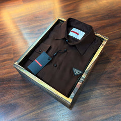Brown shirt in a box on a wooden surface