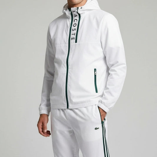 White tracksuit with Lacoste branding on a gray background