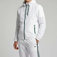 White tracksuit with Lacoste branding on a gray background