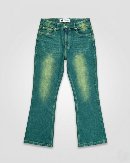 Green denim jeans on a light gray background