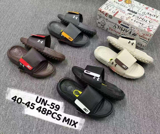 Collection of Under Armour slides on a gray surface with a branded box in the background.