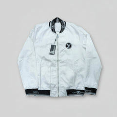 White jacket with black accents on a wooden surface
