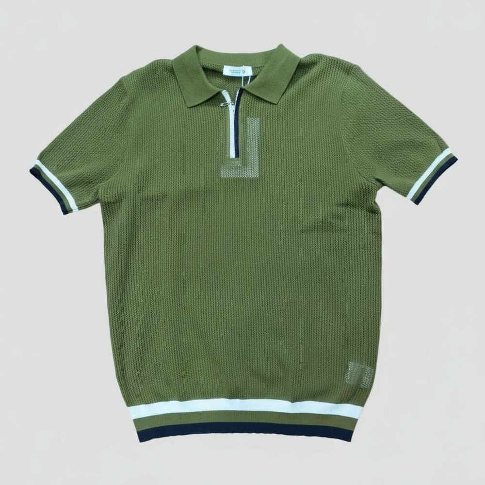 Green polo shirt with white and black trim on a light gray background