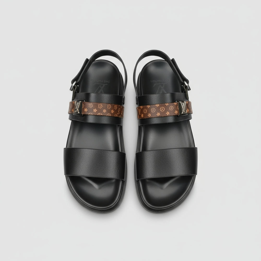 Black sandals with patterned straps on a wooden surface