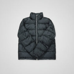 Black puffer vest on a wooden surface