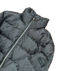 Black puffer jacket with 'Dior' logo on a wooden surface