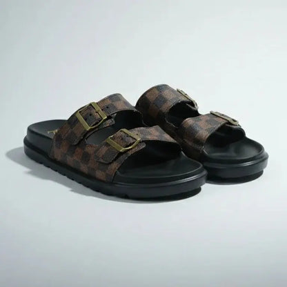 Pair of brown sandals with black soles on a light gray background