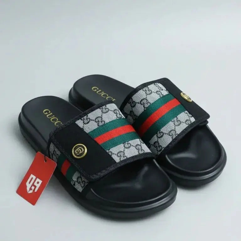 Black slide sandal with Gucci logo and tag on a light gray background