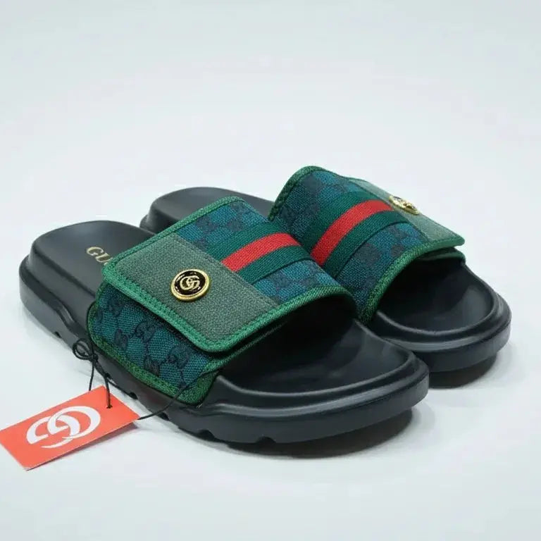 Green and black slide sandals with a red stripe on a white background