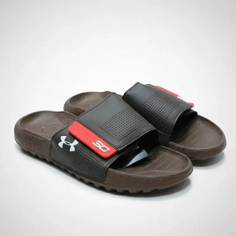 Brown slides with a red and black strap on a light gray background