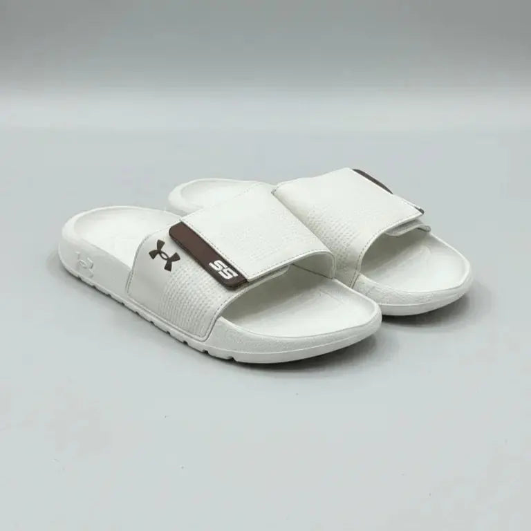 White sandals with a brown logo on a gray background