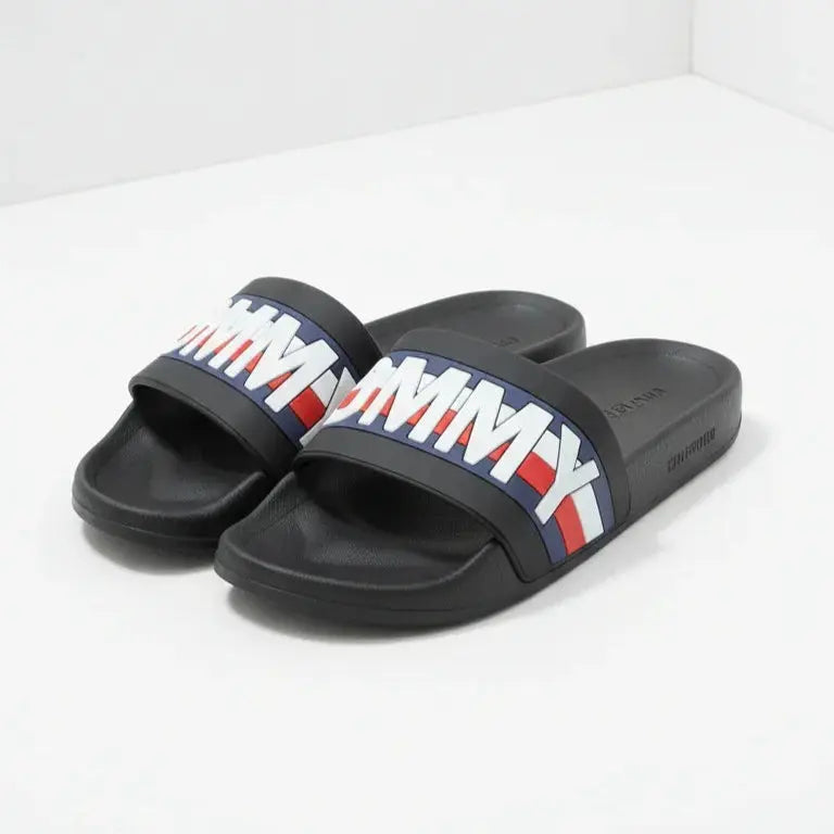 Black slides with Tommy Hilfiger logo on a white background