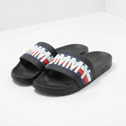 Black slides with Tommy Hilfiger logo on a white background