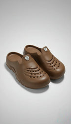 Pair of brown clogs on a light gray background