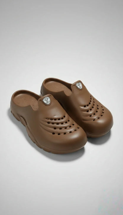 Pair of brown clogs on a light gray background