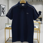 Navy blue polo shirt with brand logo on a hanger in a store setting