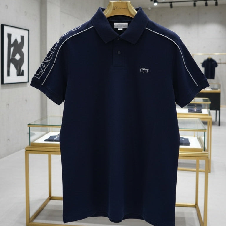 Navy blue polo shirt with brand logo on a hanger in a store setting