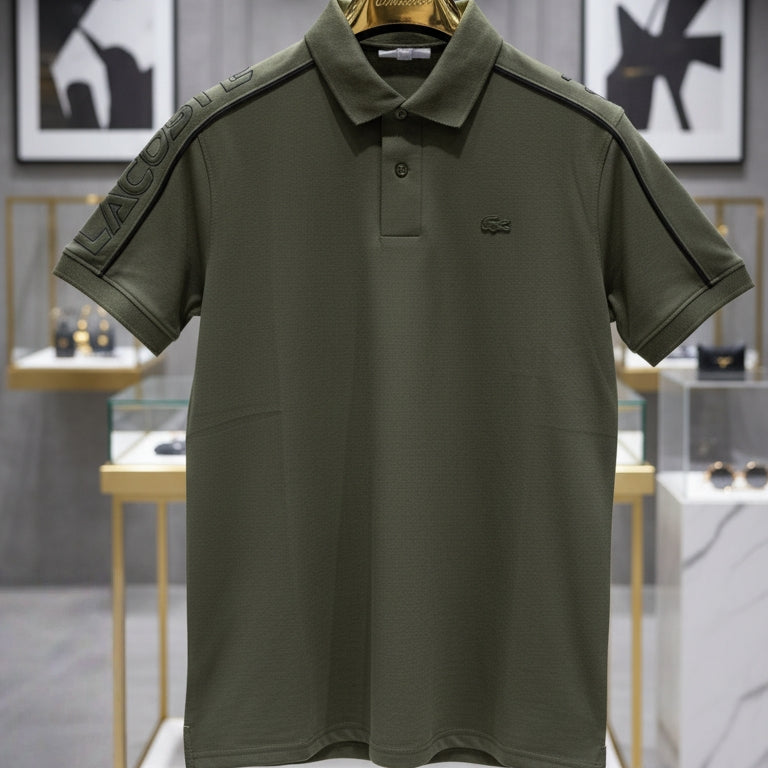 Green polo shirt on a hanger with a blurred store interior background Main image