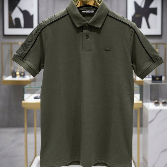 Green polo shirt on a hanger with a blurred store interior background