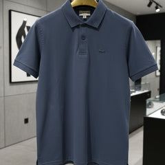 Blue polo shirt on a hanger in a store setting