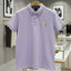 Light purple polo shirt on a hanger in a store setting