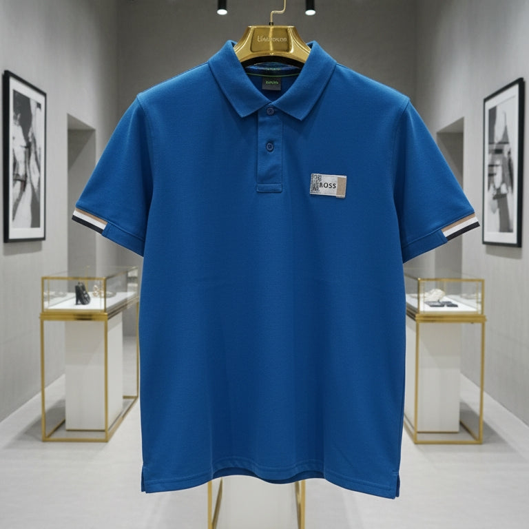 Blue polo shirt on a hanger in a store setting