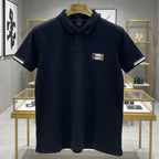 Navy blue polo shirt with a brand logo on a hanger in a store setting.