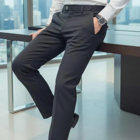 Person wearing a white shirt and dark pants in an office setting with a cityscape view. Main image