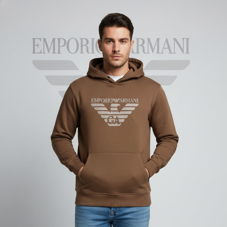 Man wearing a brown Emporio Armani hoodie on a gray background