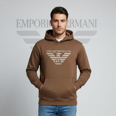 Man wearing a brown Emporio Armani hoodie on a gray background