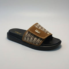 Dior slide sandal with brown strap on a gray background