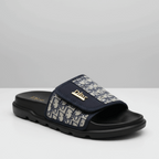 Navy slide sandal with patterned strap on a white background