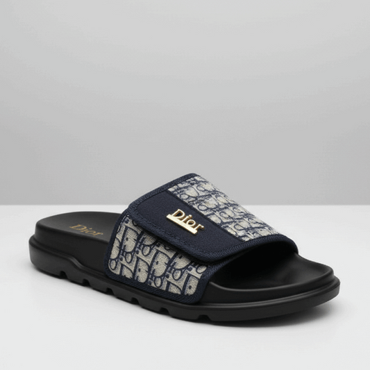 Navy slide sandal with patterned strap on a white background