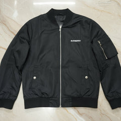 Black Burberry jacket on a light marble surface