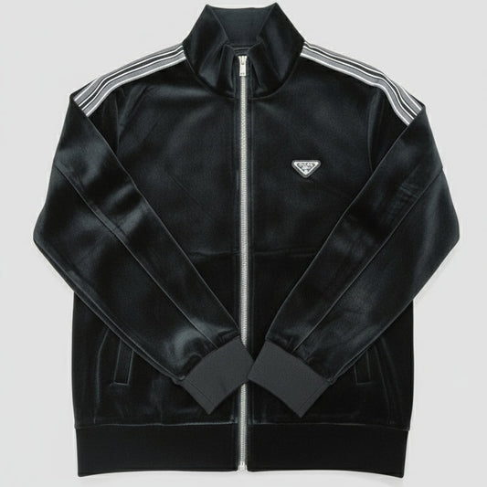 Black track jacket with white stripes on a light wooden surface