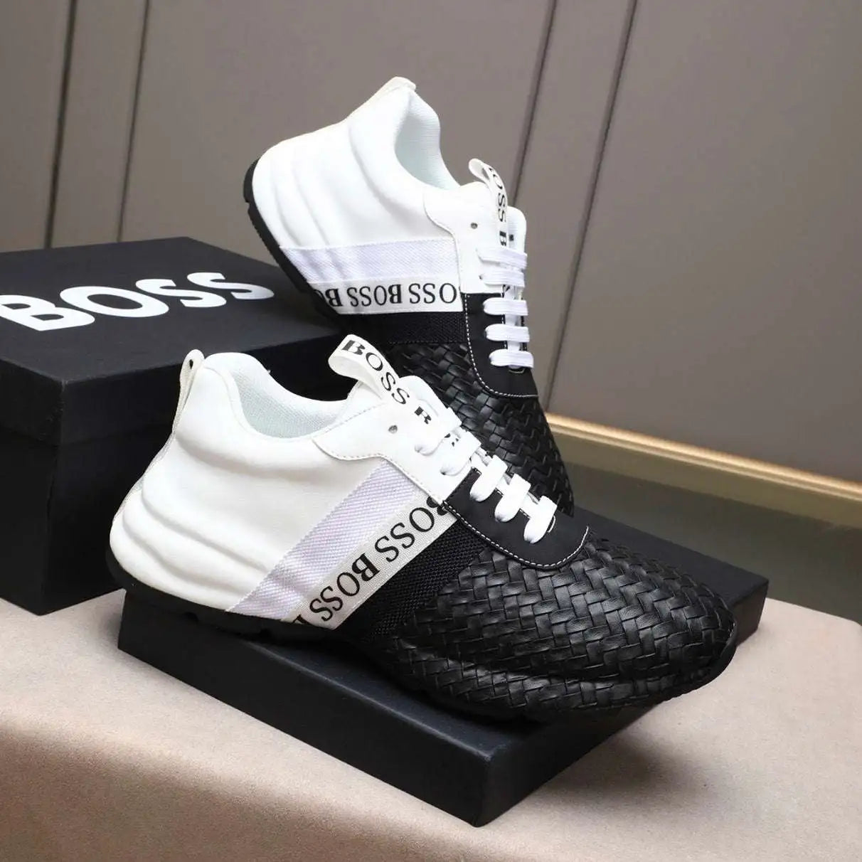 Black and white sneakers with woven pattern on a box labeled 'BOSS'. Main image