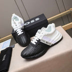 Black and white sneakers with 'BOSS' branding on a surface.