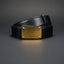 Black Dolce & Gabbana belt with gold plaque on a dark gray background