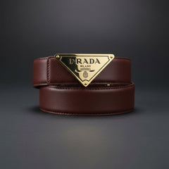 Brown leather belt with gold Prada buckle on a dark gray background