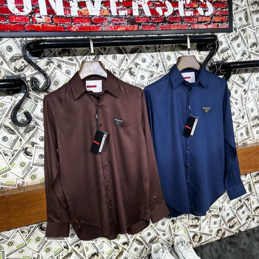 Two shirts hanging on a rack with a money-themed background