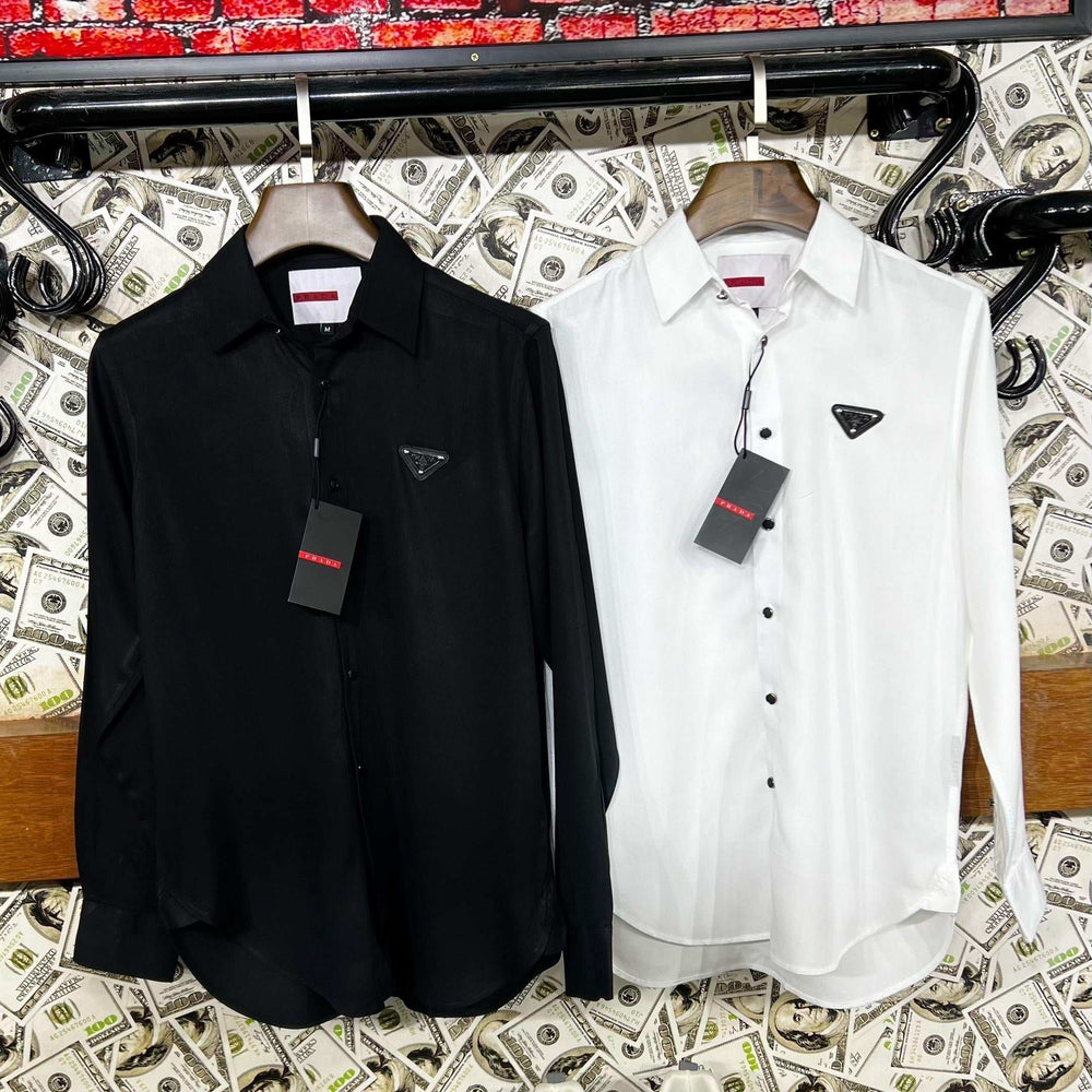 Black and white shirts with tags on a surface covered with money.