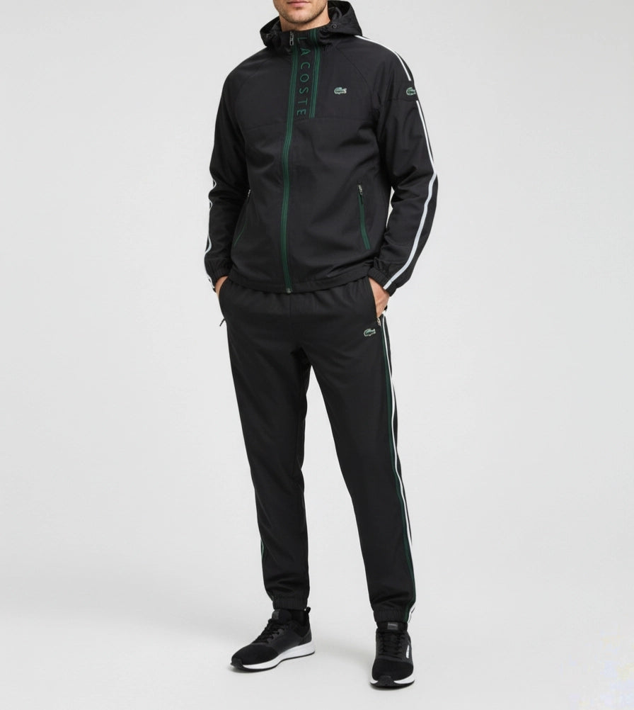 Person wearing a black tracksuit with white stripes on a light gray background Main image