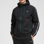 Black jacket with green accents and Lacoste branding on a gray background