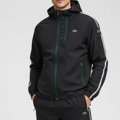Black jacket with green accents and Lacoste branding on a gray background