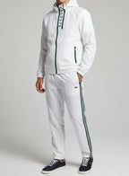 Person wearing a white tracksuit with brand logo on a plain background