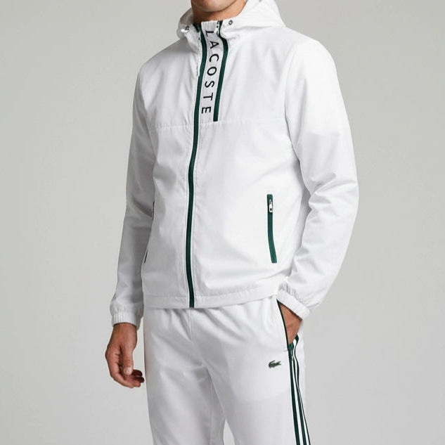 White tracksuit with Lacoste branding on a gray background